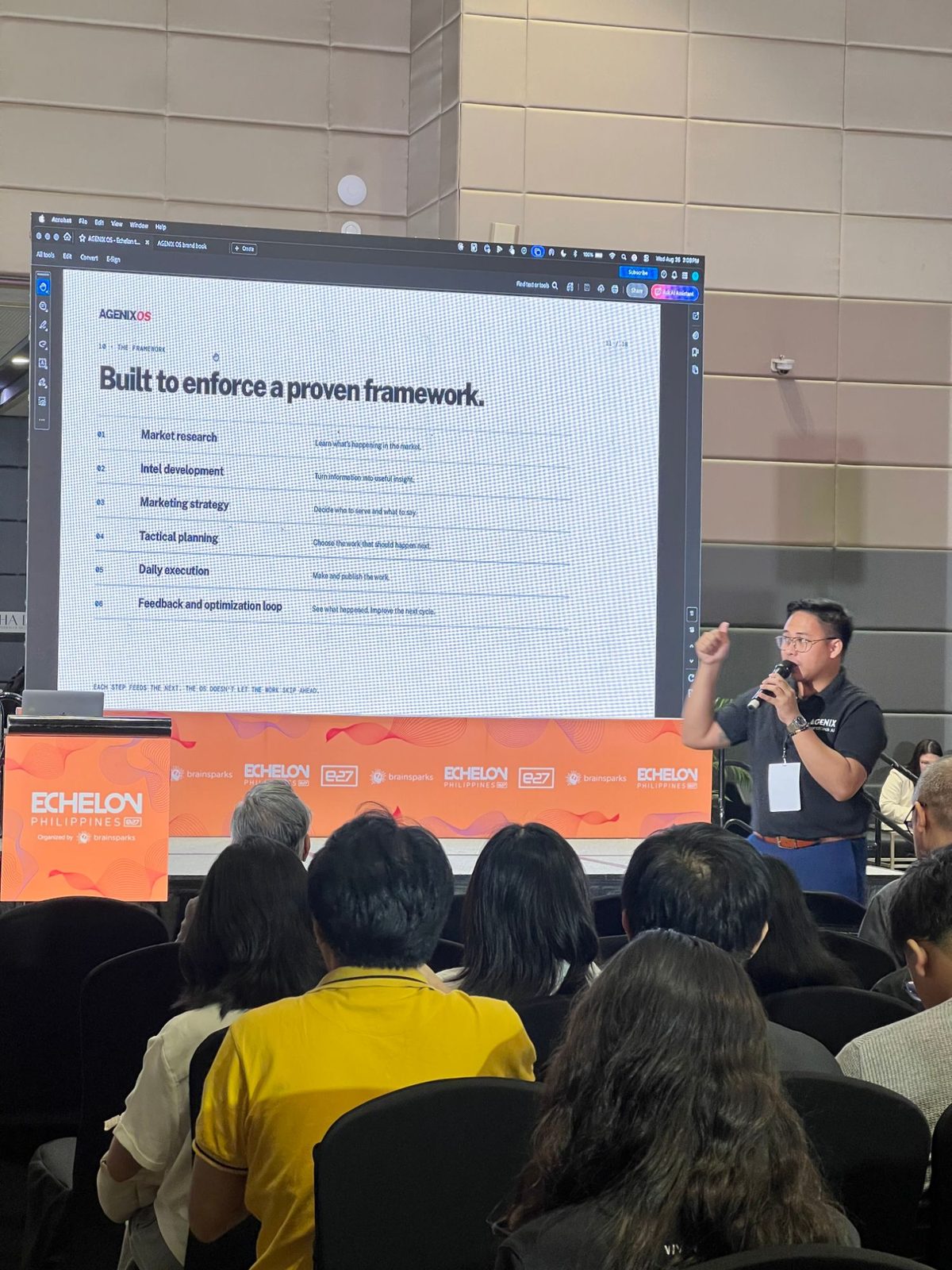 Clarry Herrera presenting the AGENIX OS framework on stage at Echelon Philippines
